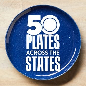 50 Plates Across The States Logo on a blue plate on a light wood surface