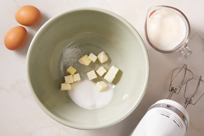 eggs next to butter and sugar in a bowl