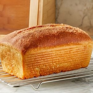 A whole bread on a wire rack